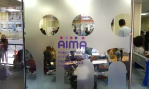 Applicants waiting inside and outside an AIMA immigration office in Portugal